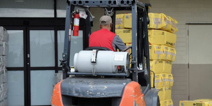 Man driving a forklift in a warehouse, the kind of work forklift training prepares for